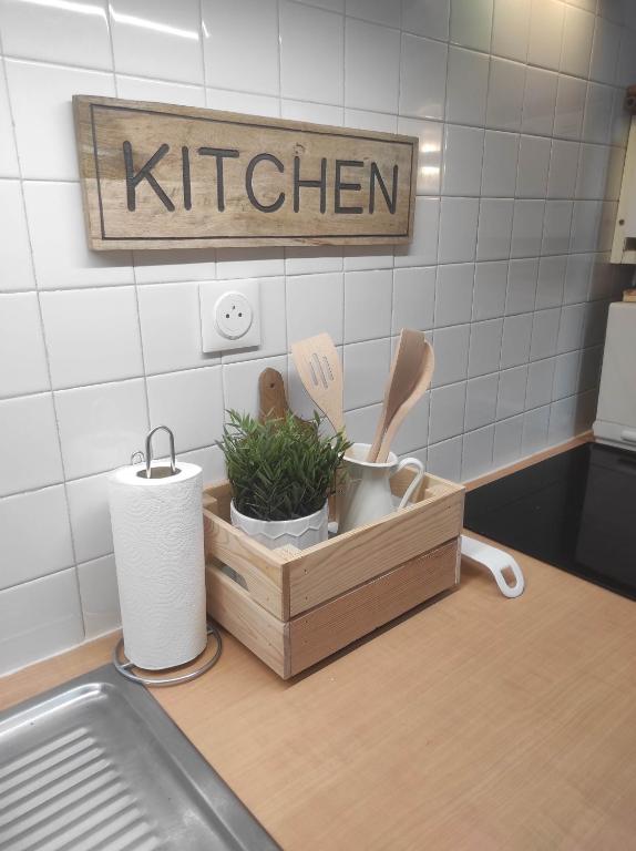 a kitchen counter with a wooden tray with utensils at Chill Out Cabanon Coeur Calanques in Marseille