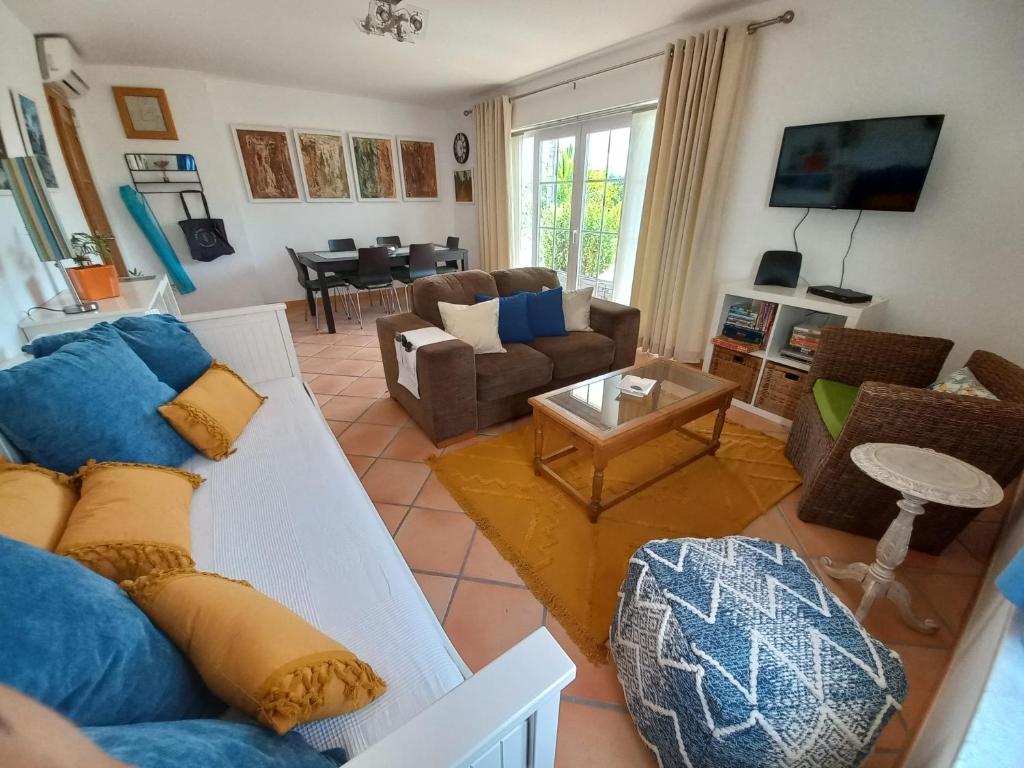 a living room with a couch and a table at Aldeia Formosa - Cabanas de Tavira in Cabanas de Tavira