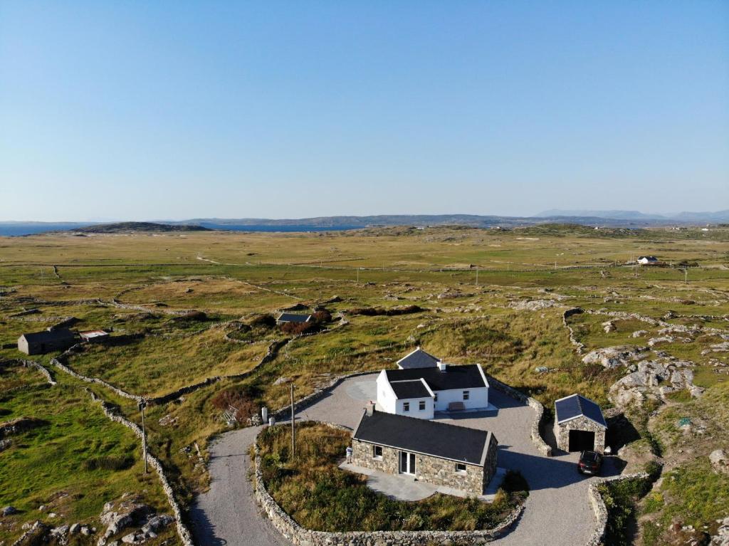 an aerial view of a house in a field at Paddy Carrolls Cottage in Ballyconneely