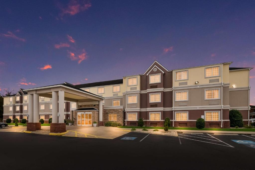 a rendering of the front of a hotel with a parking lot at SureStay Plus Hotel by Best Western Elizabeth City in Elizabeth City