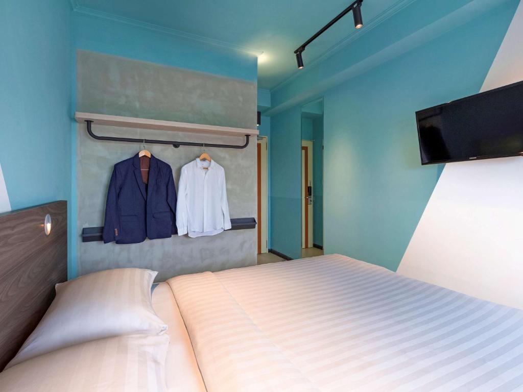 Postel nebo postele na pokoji v ubytování ibis budget Phnom Penh Riverside