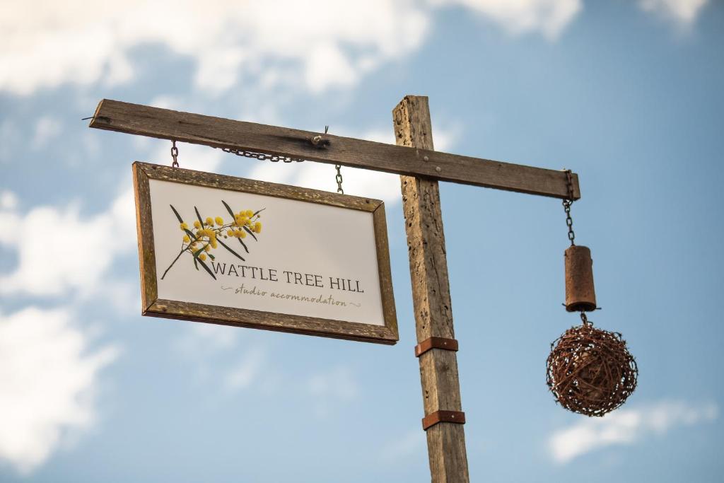 a sign for a wildlife tree fill on a pole at WATTLE TREE HILL in Gundagai