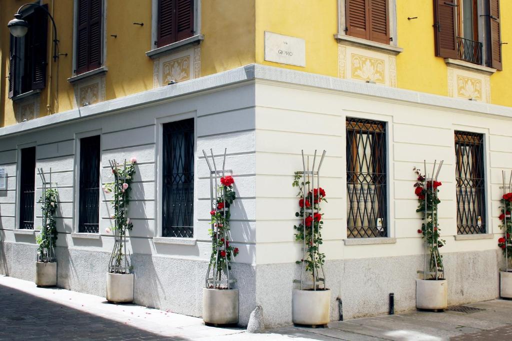 un edificio con composizioni floreali sul lato di esso di Residence Diaz a Como
