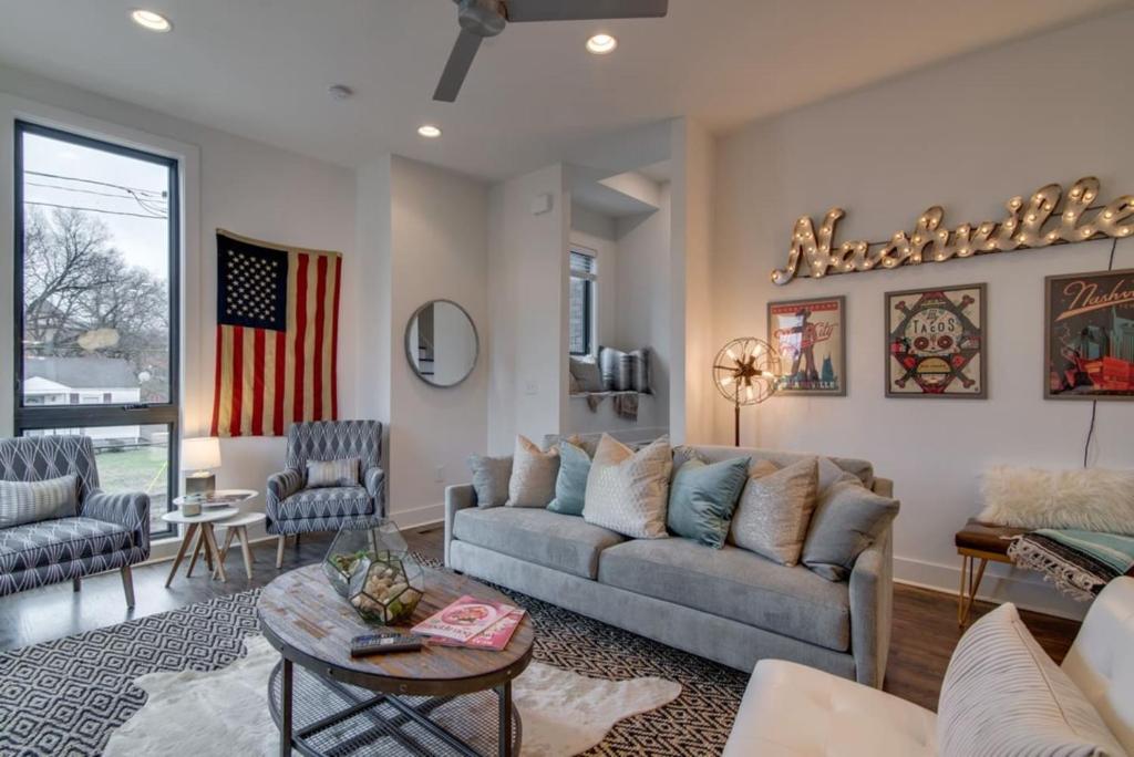 a living room with a couch and a table at The Kora - Stylish Rooftop Retreat in Gulch in Nashville