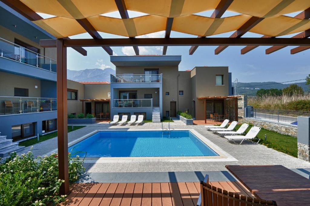 a view of a house with a swimming pool at Mary's Residence Suites in Chrysi Ammoudia