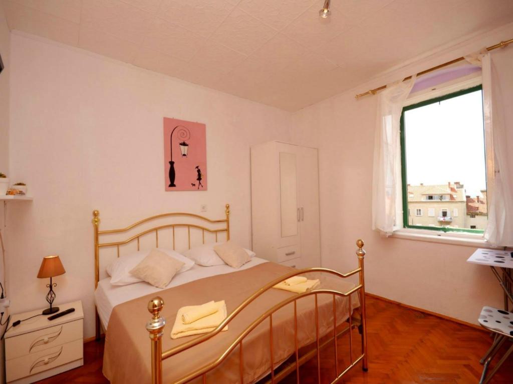 a bedroom with a bed and a window at Ana in Split