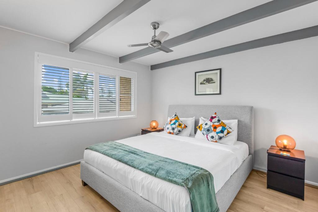 a bedroom with a bed and a window at Stingray in Ballina