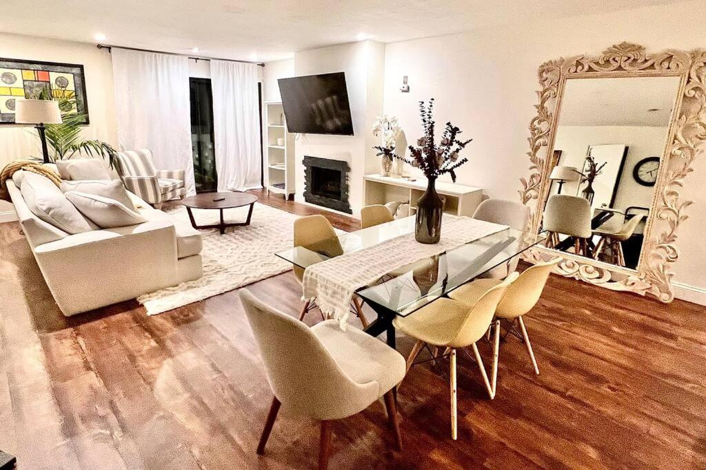 a living room with a table and chairs and a mirror at Cozy Private Condo near Hall of Fame in Hollywood in Los Angeles