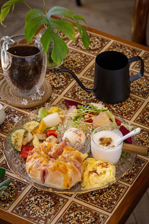 a table with a plate of food and a cup of coffee at Queen Love Homestay in Hualien City