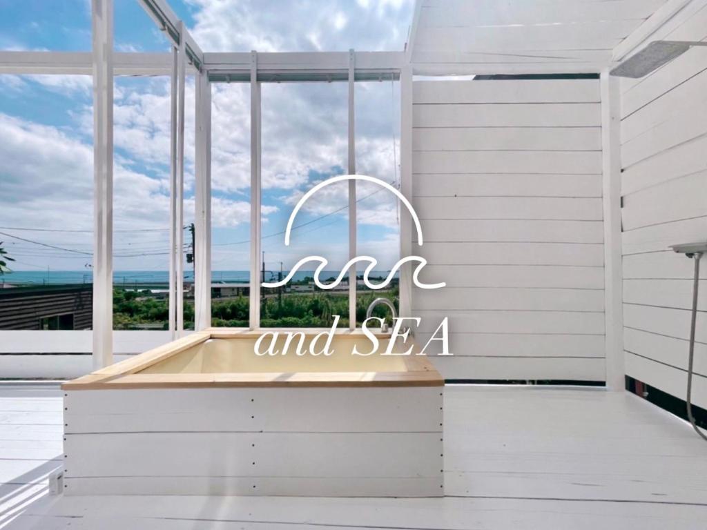 a kitchen with a large window and a sign that reads am and sea at and SEA Kamogawa - Vacation STAY 07561v in Kamogawa