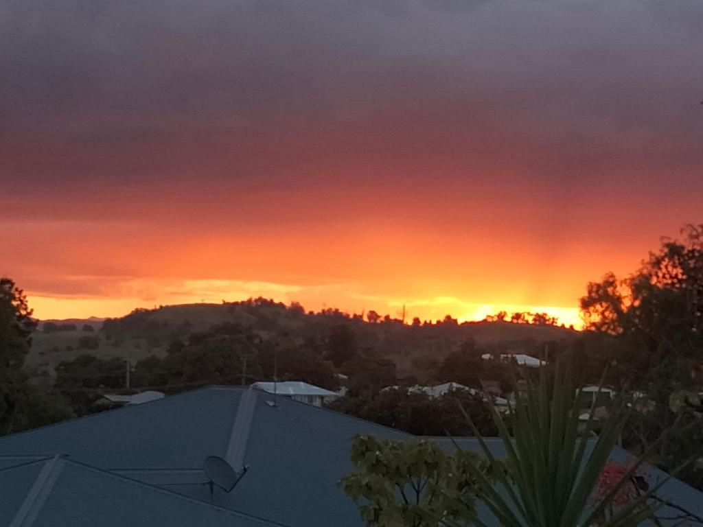 a sunset from the roof of a house at Seventeen Mc Bean Scenic Getaway in Boonah