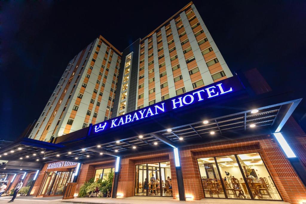 a hotel with a sign on the front of it at Kabayan Hotel Pasay in Manila