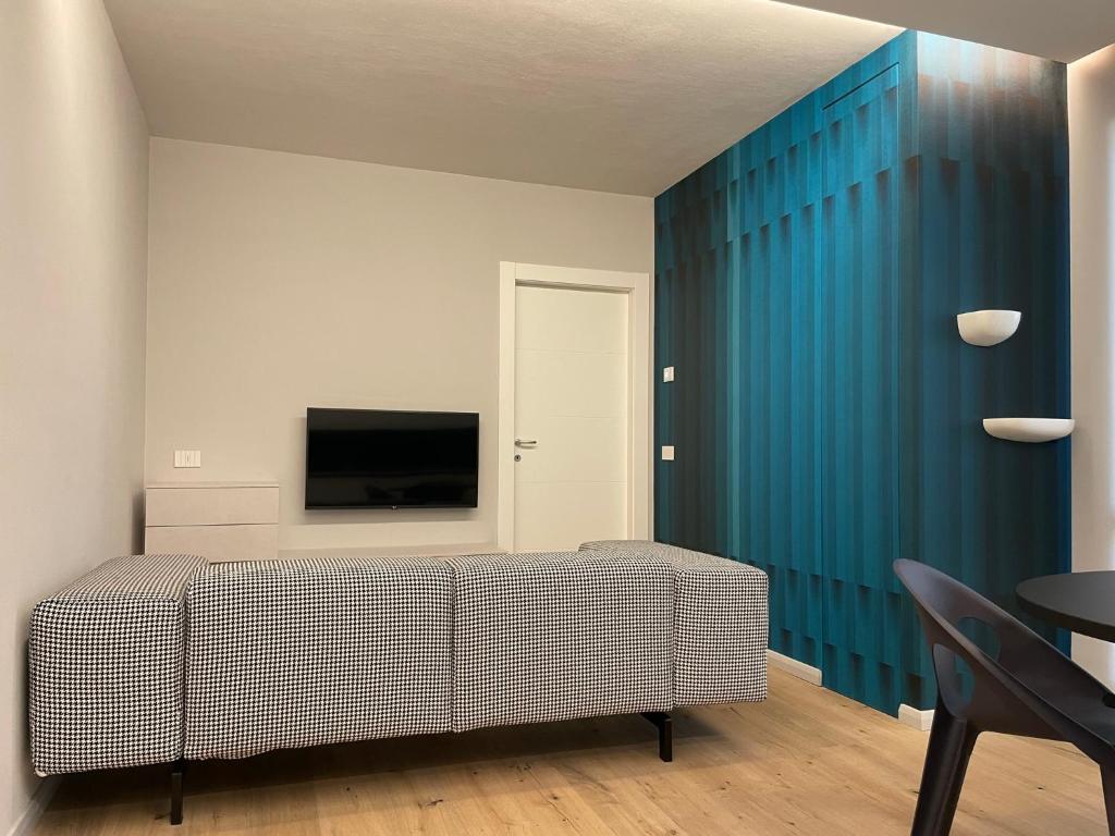 a bedroom with a bed and a blue wall at A10 Palazzo Marconi Apartment in San Giovanni Valdarno