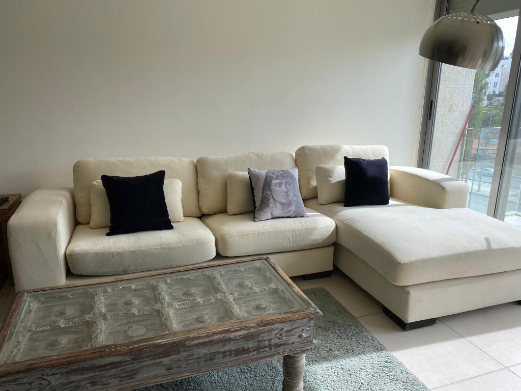 a living room with a couch and a coffee table at Grand Residence apartment in Amman