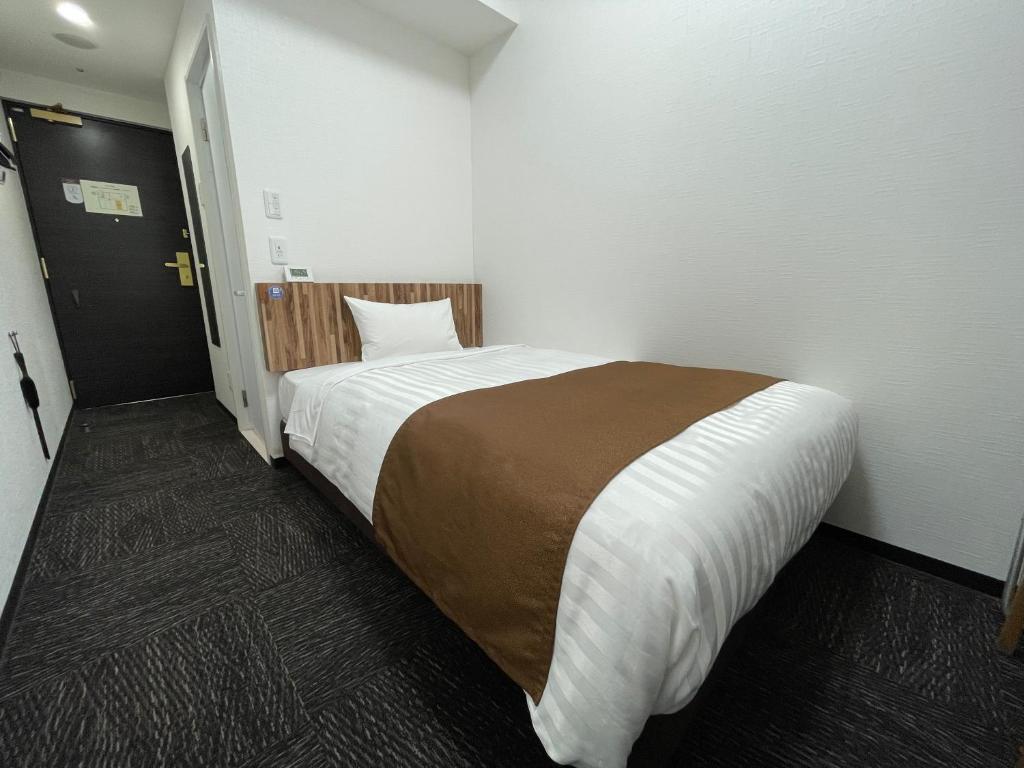 Postel nebo postele na pokoji v ubytování Ueno Urban Hotel Annex