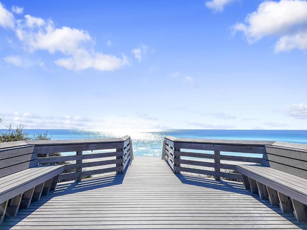 a wooden boardwalk leading to the beach with the ocean at Hidden Beach Villas - 111 Villa in Santa Rosa Beach