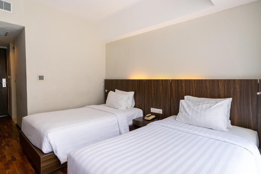 Postel nebo postele na pokoji v ubytování The Bene Hotel