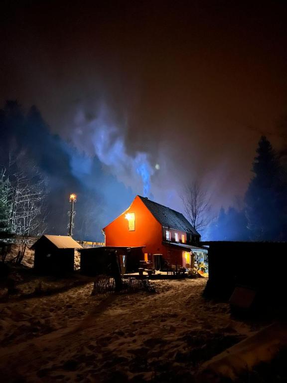 a red barn at night with a cloudy sky at Ferienwohnung "An der schönen Bahra" in Bahra