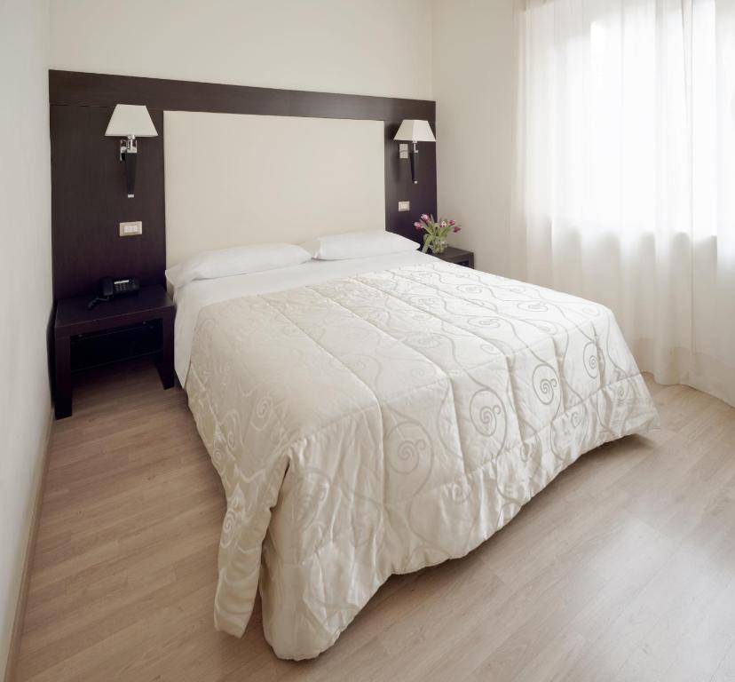 Postel nebo postele na pokoji v ubytování Hotel Aurora