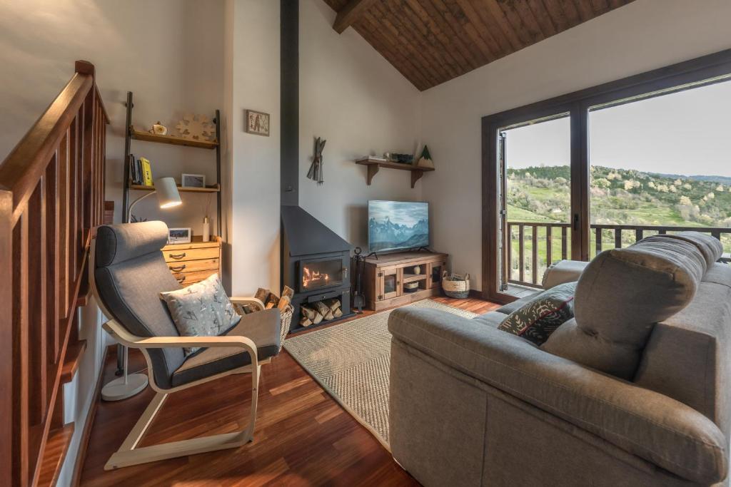 a living room with a couch and chairs and a fireplace at CAN ROC in Camprodon