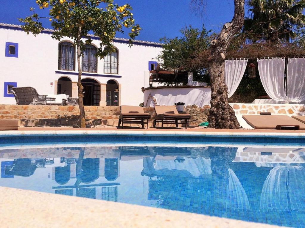 a swimming pool in front of a house at Agroturismo Can Marquet - Adults Only in Santa Gertrudis de Fruitera