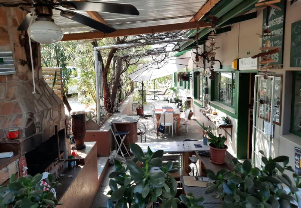 an outdoor patio with tables and potted plants at Xenia Bed & Breakfast in Windhoek