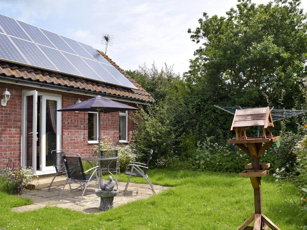 a house with solar panels on the roof at Mickrandella in Martham