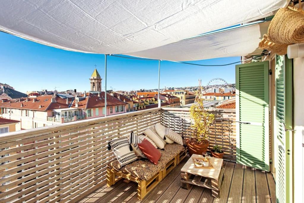 a balcony with a couch and a view of a city at #9 Opera's Duplex panoramic Sea View Terrace & AC 1min to Beach in Nice