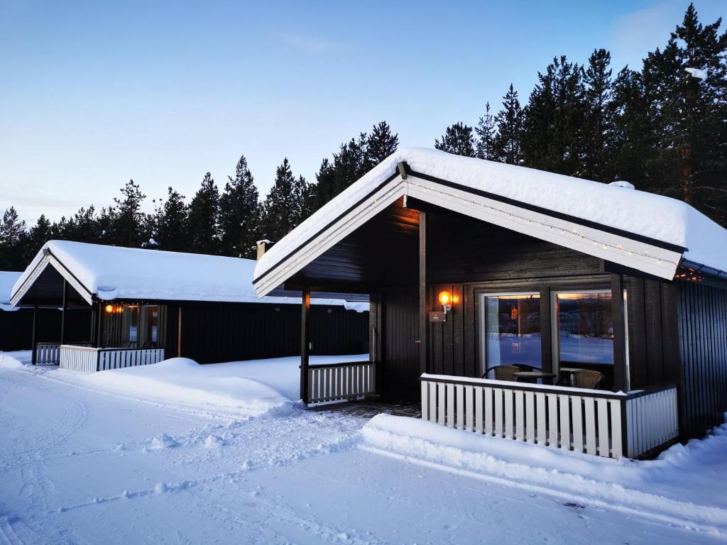 a cabin in the snow with snow covered ground at Min Ája in Karasjok