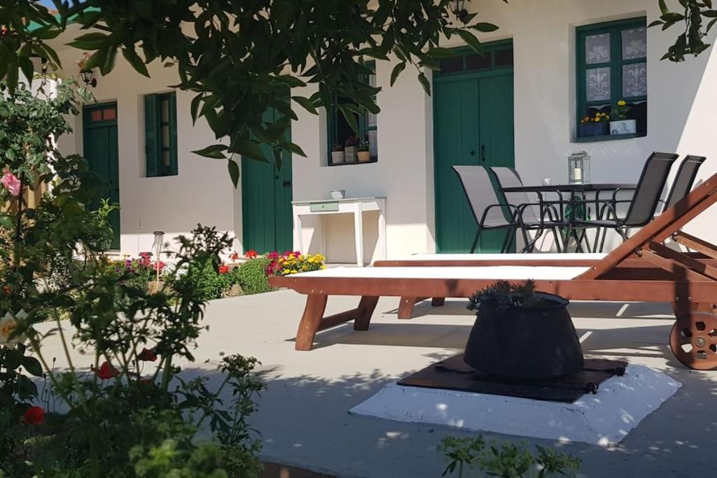 a picnic table in a courtyard with a table and chairs at Erofili cottage house in Elounda