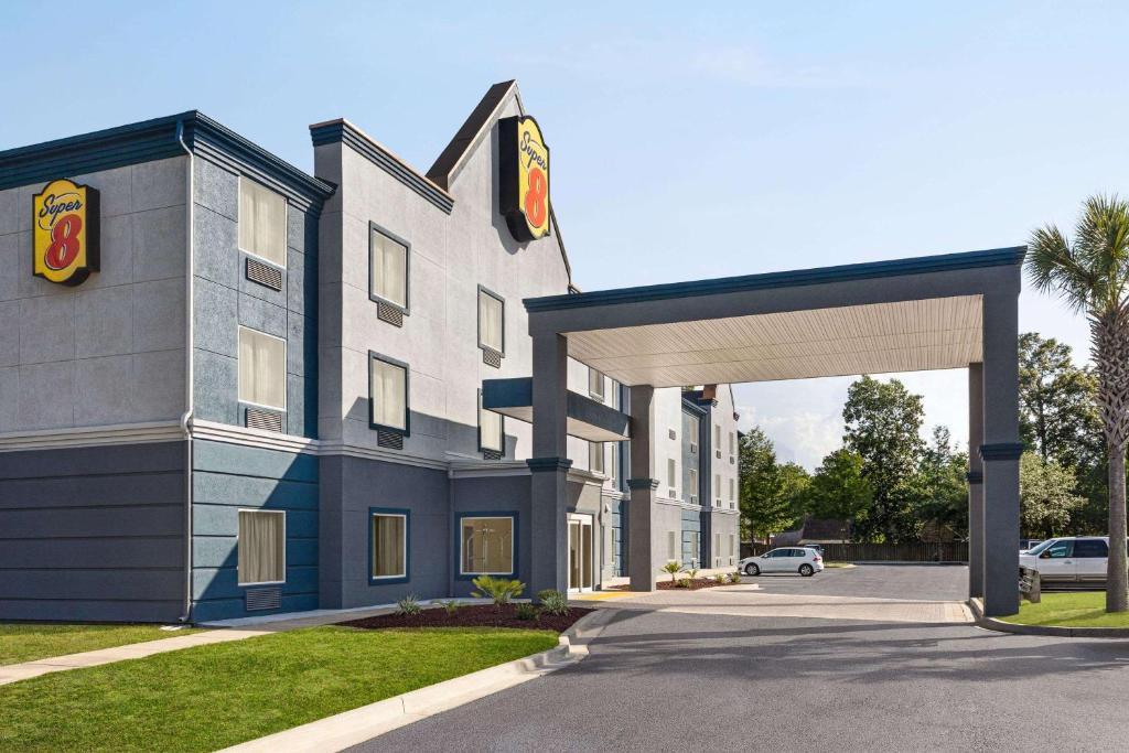a rendering of a hotel with a building at Super 8 by Wyndham Savannah in Savannah