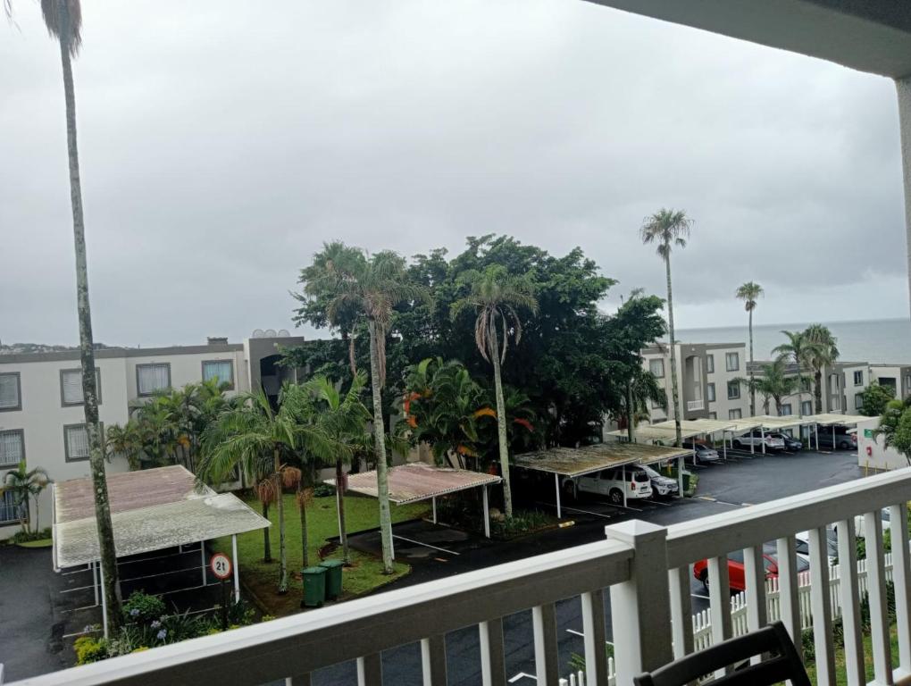 a balcony view of a parking lot with palm trees at Laguna La Crete 163 in Margate