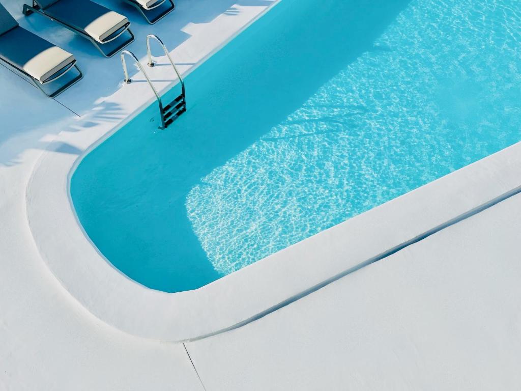 a swimming pool with a swing in the water at CIH Apartments in Puerto del Carmen