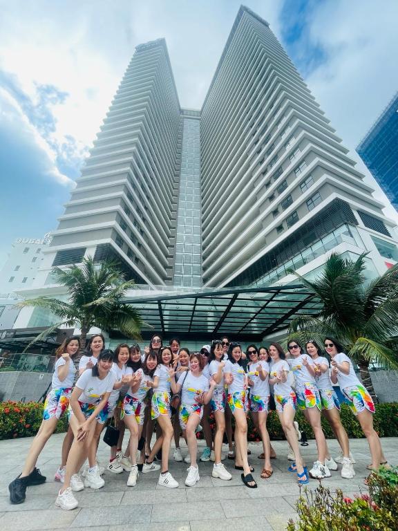 a group of people posing in front of a building at FLC Ocean View Quy Nhon in Quy Nhon