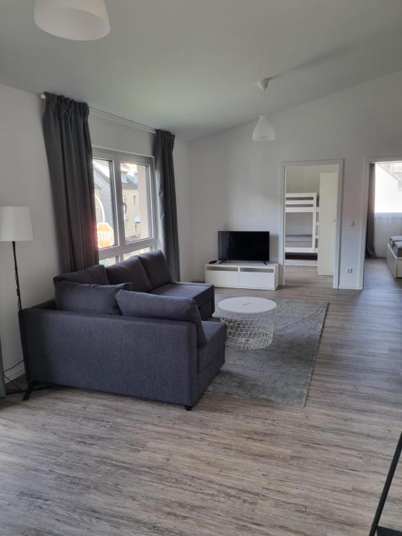 a living room with a couch and a table at Ferienwohnung Euchen in Würselen