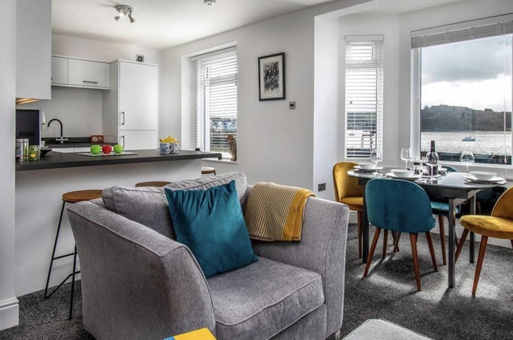a kitchen and a living room with a table and chairs at Oakdene in Deganwy