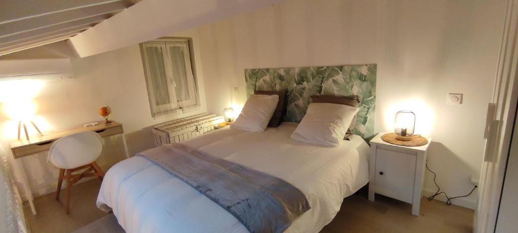 a bedroom with a large bed with two lamps on it at Chill Out Cabanon Coeur Calanques in Marseille