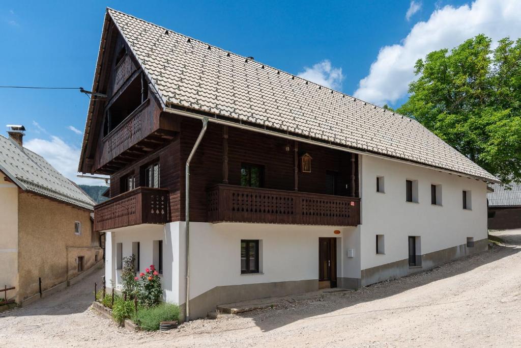 a large wooden house with a balcony at Rudnica House in Bohinj