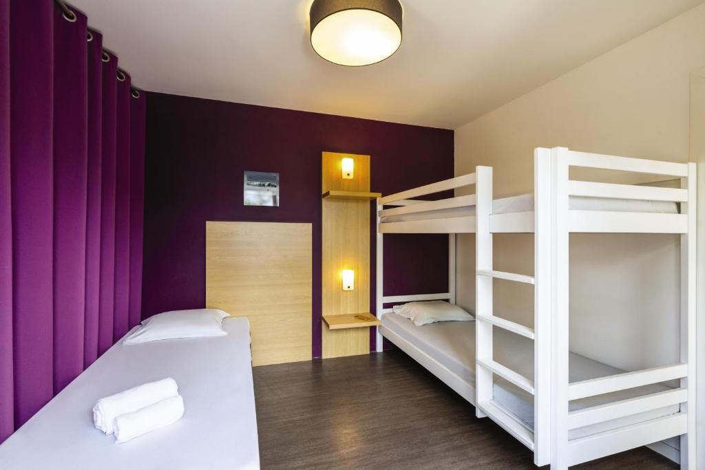 a bedroom with two bunk beds and purple walls at Belambra Clubs Capbreton - Les Vignes in Capbreton