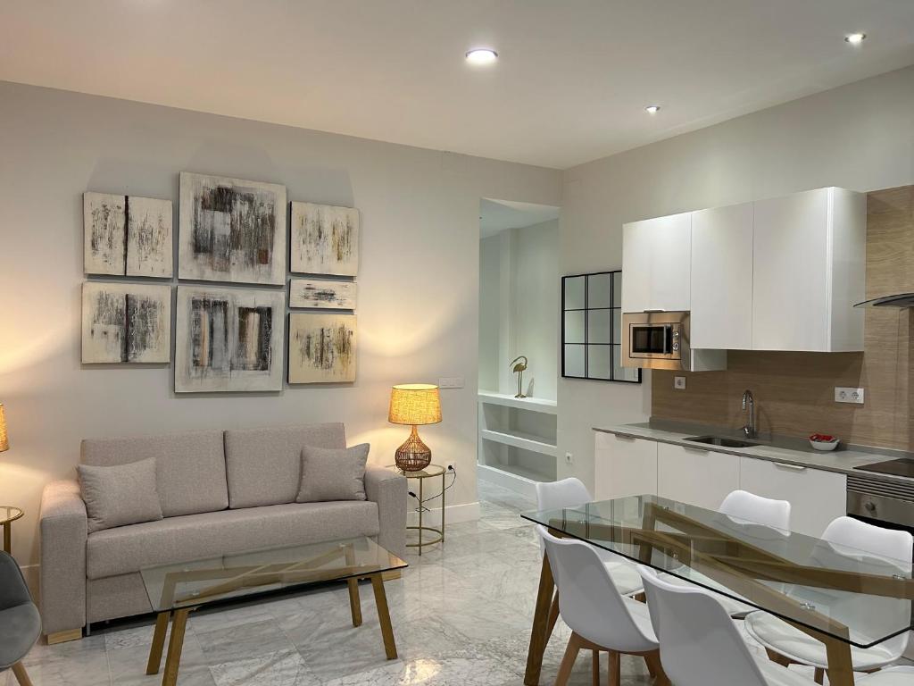 a living room with a couch and a table at Olavide Premium Apartments in Seville