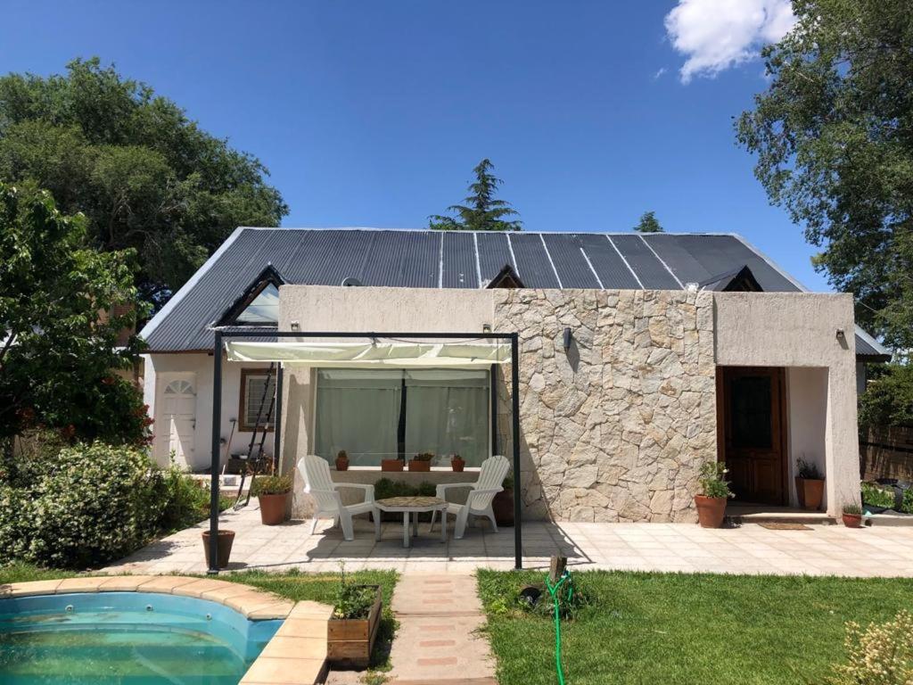 a house with a patio and a pool at BanTelmo in Juana Koslay 