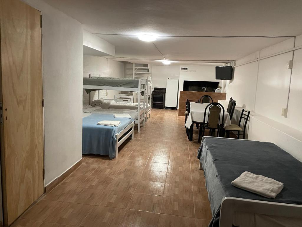 um quarto com 2 beliches, uma mesa e cadeiras em Departamento Loft hasta 10 personas em Paraná