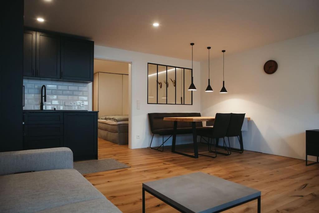 a kitchen and living room with a table and a dining room at Schwarzwald Loft Menzenschwand in Menzenschwand