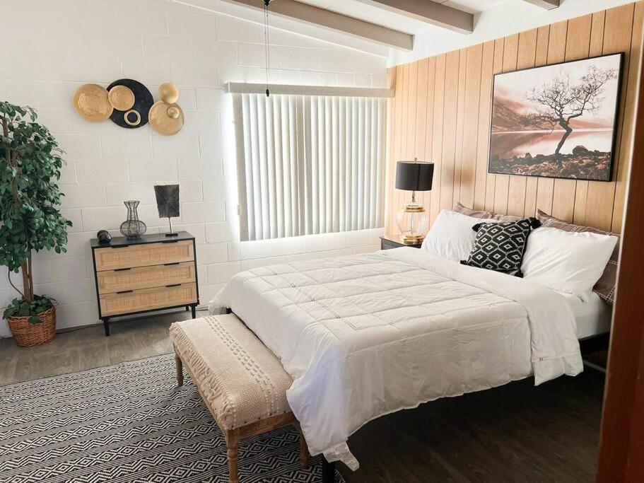 a bedroom with a large white bed and a window at Joshua Tree National Park - Cozy Palms Getaway in Twentynine Palms