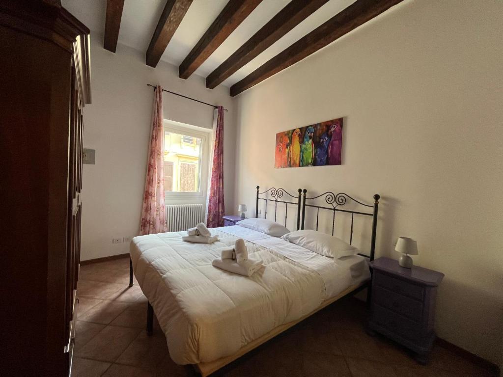 a bedroom with a bed with two towels on it at Residenza Montecchi in Verona
