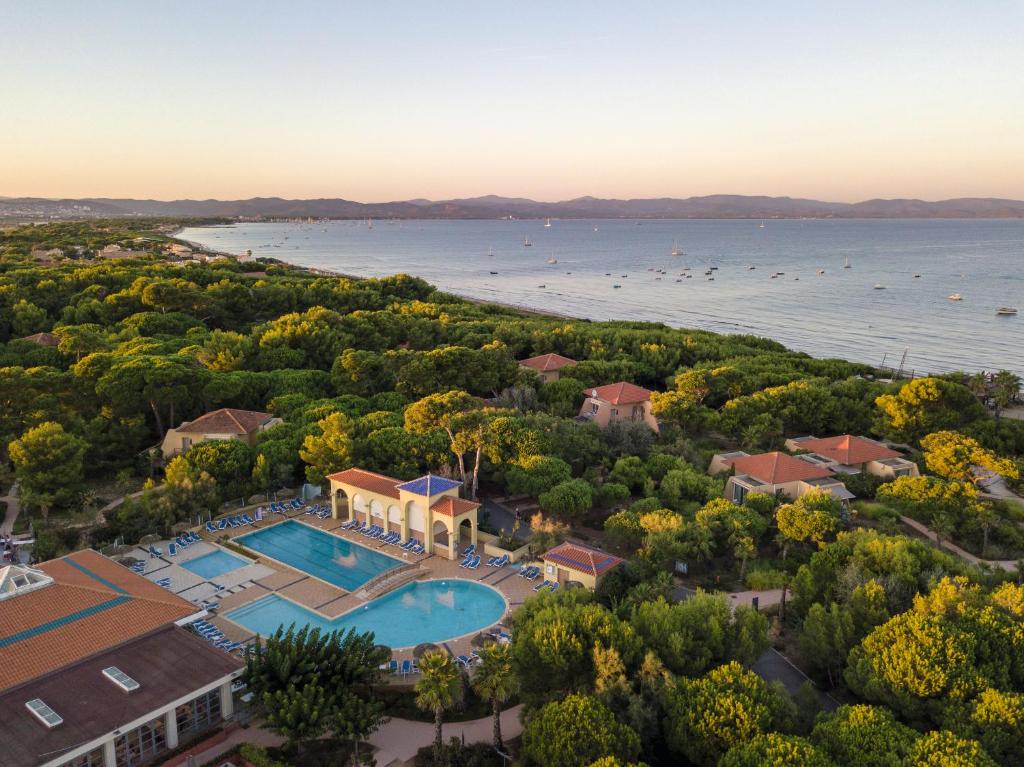 an aerial view of a resort with a pool and the water at Belambra Clubs Presqu'île De Giens - Riviera Beach Club in Hyères