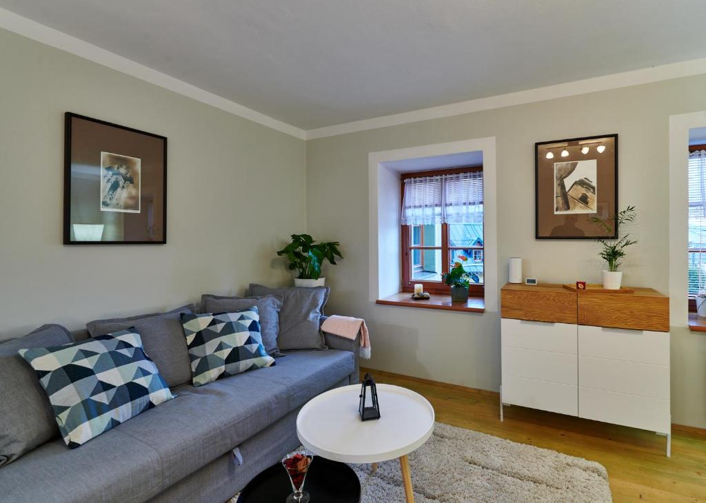 a living room with a couch and a table at Banská Štiavnica - Apartmán 1 in Banská Štiavnica