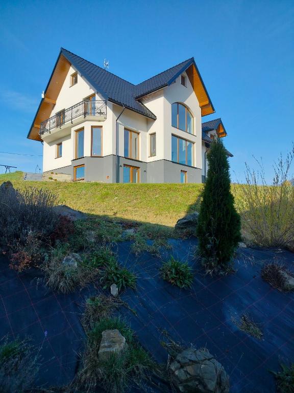 a large house on top of a hill at Apartament Oliwia in Grywałd