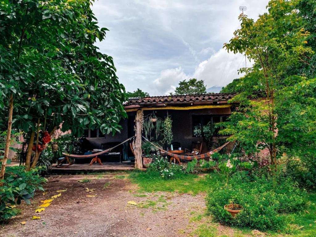 a house with a hammock outside of it at Casa Papaki in Mérida