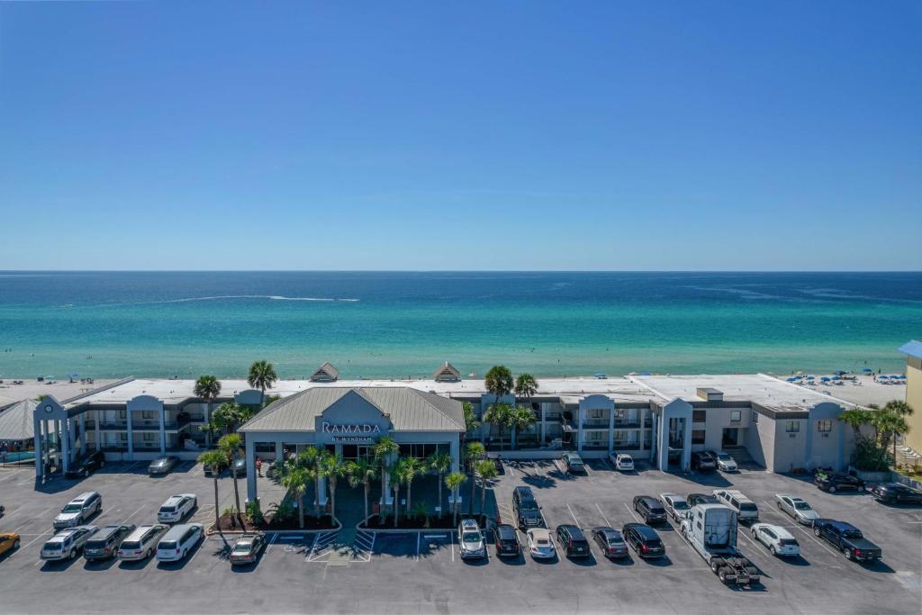 an aerial view of a resort with a parking lot at Ramada by Wyndham Panama City Beach / Beachfront in Panama City Beach